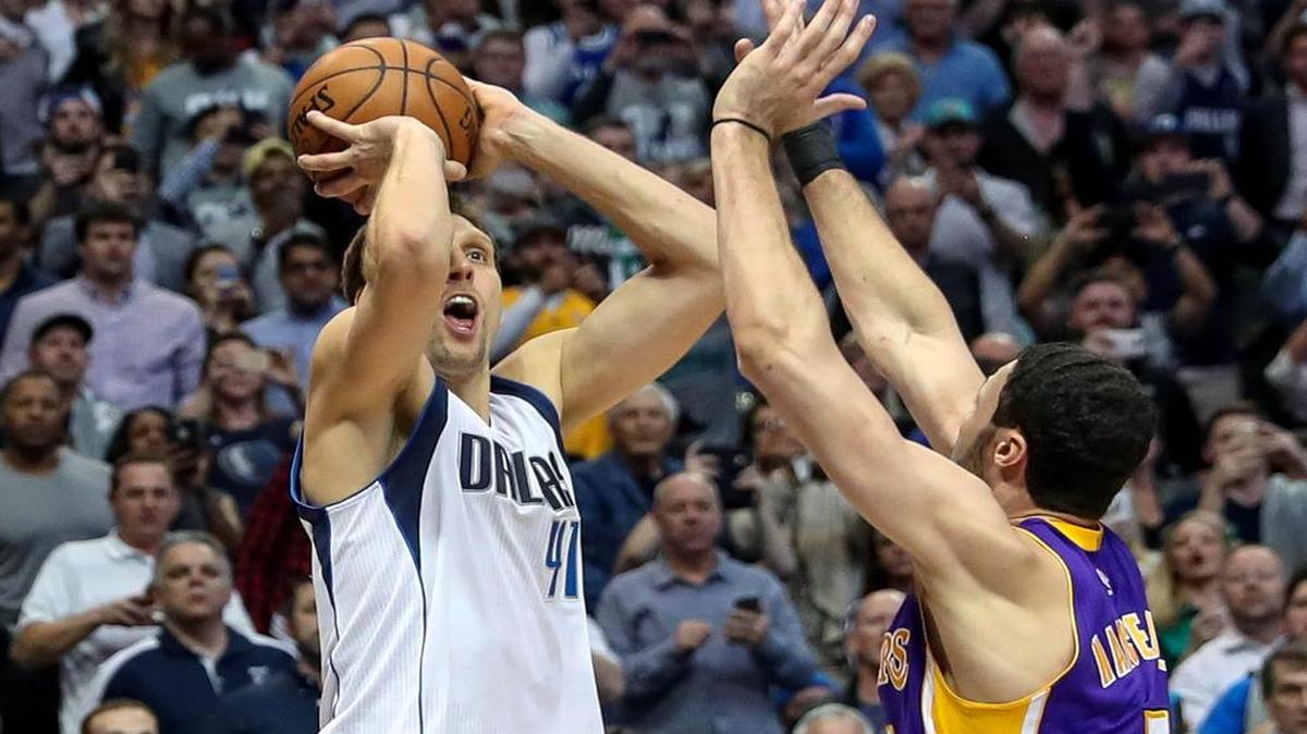 Dirk Nowitzki, left, sinks a shot over Lakers forward Larry Nance Jr. on Tuesday to reach the 30,000-point milestone for his career. Nowitzki and the Mavericks return to action Friday at home against the Brooklyn Nets. The game will be televised at 8 p.m. on Fox Sports Southwest.