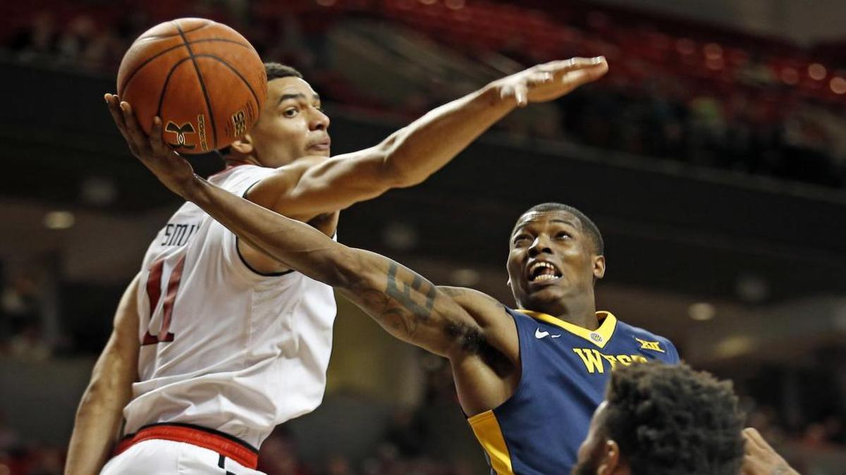Teyvon Myers, right, of West Virginia drives around Texas Tech’s Zach Smith during Tuesday’s game in Lubbock. The No. 7 Mountaineers, who were upset by a last-second shot, play host to TCU on Saturday in a Big 12 matchup. The game tips off at noon on ESPNU.