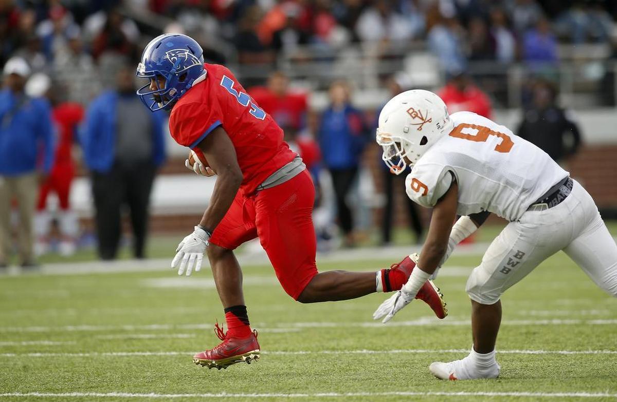 Duncanville running back Tre Siggers (5) gets past Arlington Bowie defensive back Khari Clarkson (9) in the second half of high school playoff football action at Newsom Stadium in Mansfield, Texas on Saturday, Nov. 26, 2016. Duncanville won 32-27.