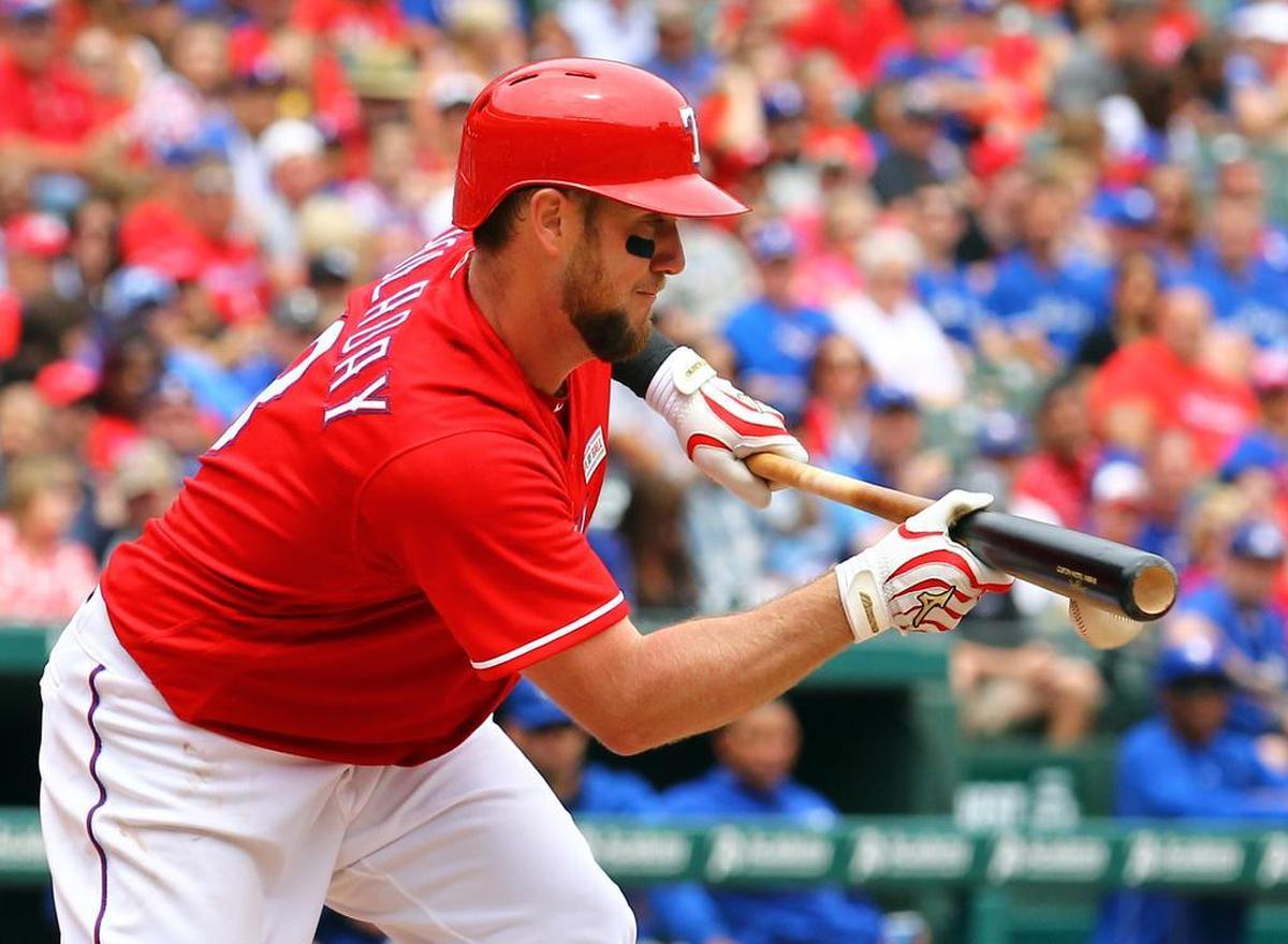 Texas Rangers Bryan Holaday (8) hits a sacrifice bunt in the third inning against the Toronto Blue Jays at Globe Life Park in Arlington Sunday May 15, 2016.