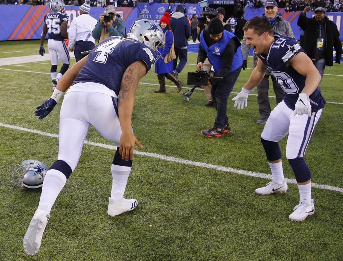 Dallas Cowboys quarterback Dak Prescott (4) and kick returner Ryan Switzer (10) celebrate after the Cowboys beat the Giants 30-10.
