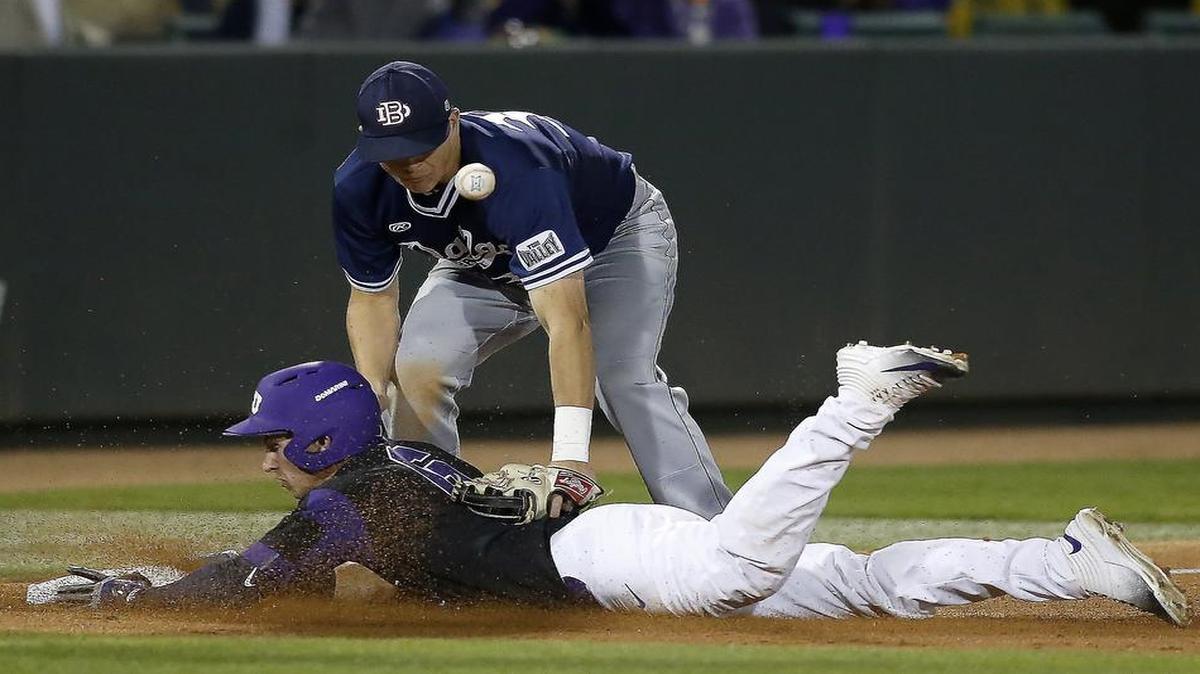 TCU’s Nolan Brown slides in with a triple ahead of the tag of Dallas Baptist’s Tim Millard on March 7 in a game won by the Horned Frogs 3-2 in 10 innings. The teams meet in a rematch Tuesday at Dallas Baptist. The game will be streamed live online at ESPN3 starting at 6:30 p.m.
