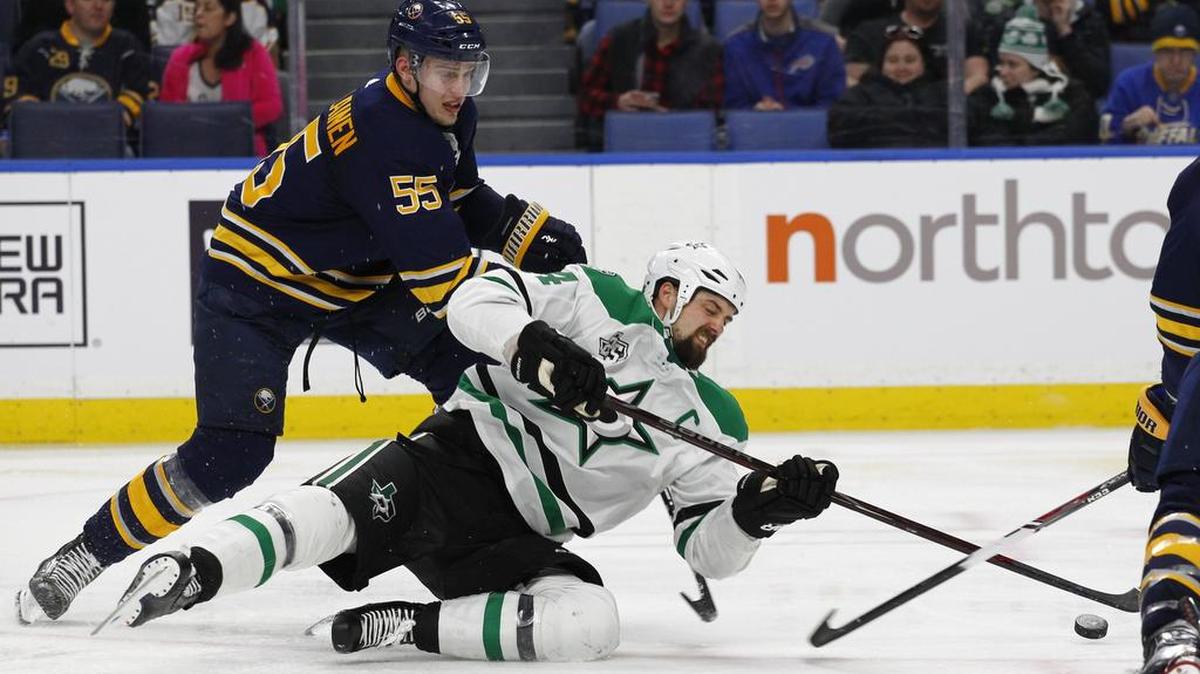 Sabres defenseman Rasmus Ristolainen (55) brings down Stars forward Jamie Benn (14) during the second period of Saturday’s game in Buffalo.