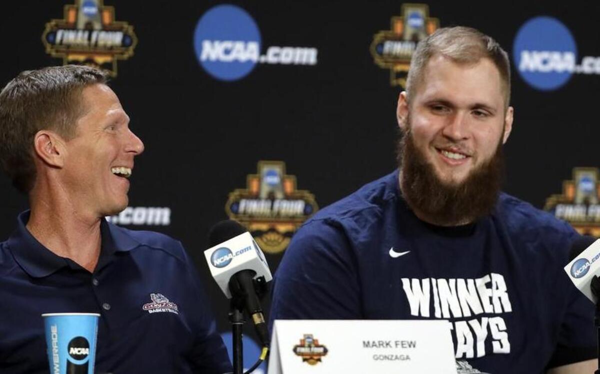 Gonzaga head coach Mark Few, left, laughs with Przemek Karnowski during a news conference for the Final Four NCAA college basketball tournament on Sunday in Glendale, Ariz.
