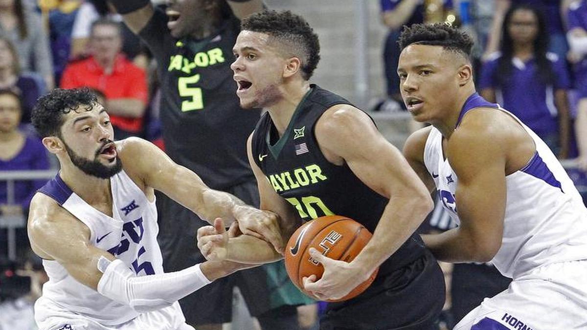 TCU guards Alex Robinson, left, and Desmond Bane, going for the steal agaisnt Baylor guard Manu Lecomte on Saturday, will look for a key road win at Okalhoma State at 6 p.m. Monday on ESPNU.