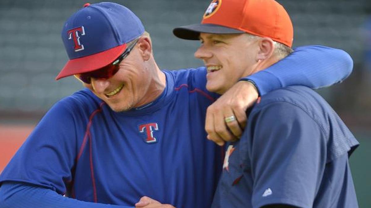 Texas Rangers manager Jeff Banister, left, hugs Houston Astros manager A.J. Hinch before a game in September at Globe Life Park. The managers had been in a heated shouting match earlier in the 2015 season.