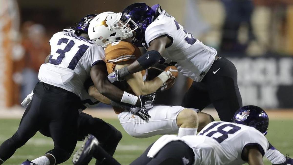 TCU defenders Ridwan Issahaku, left, Travin Howard, right, and the Horned Frogs wrap up their regular season Saturday at home against Kansas State. The game will be televised at 11 a.m. on FS1.