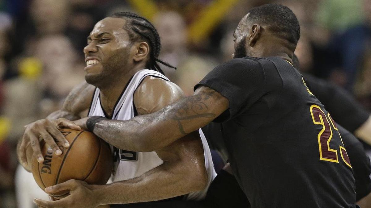 San Antonio Spurs forward Kawhi Leonard, left, wrestles the ball away from Cleveland Cavaliers forward LeBron James during Saturday’s game. Leonard scored a career-high 41 points as the Spurs prevailed in overtime 118-115 against the defending champs. Leonard and the Spurs on Tuesday play the second half of a road back-to-back at Toronto. NBA TV has the coverage beginning at 6 p.m.