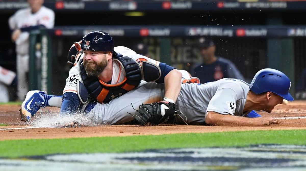 The Los Angeles Dodgers’ Austin Barnes is tagged out by Houston Astros catcher Brian McCann while trying to score from third base in the sixth inning.