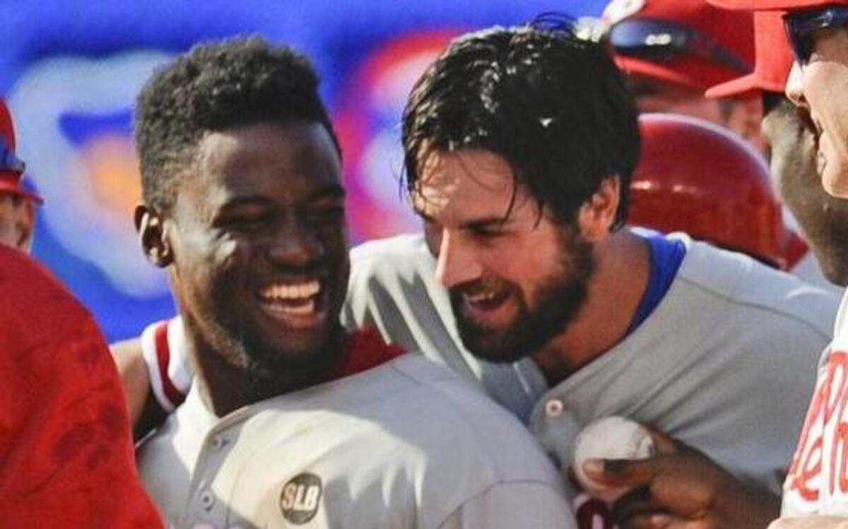 
Phillies ace Cole Hamels, right, hugs center fielder Odubel Herrera, whose stumble added to the no-hit drama. 
