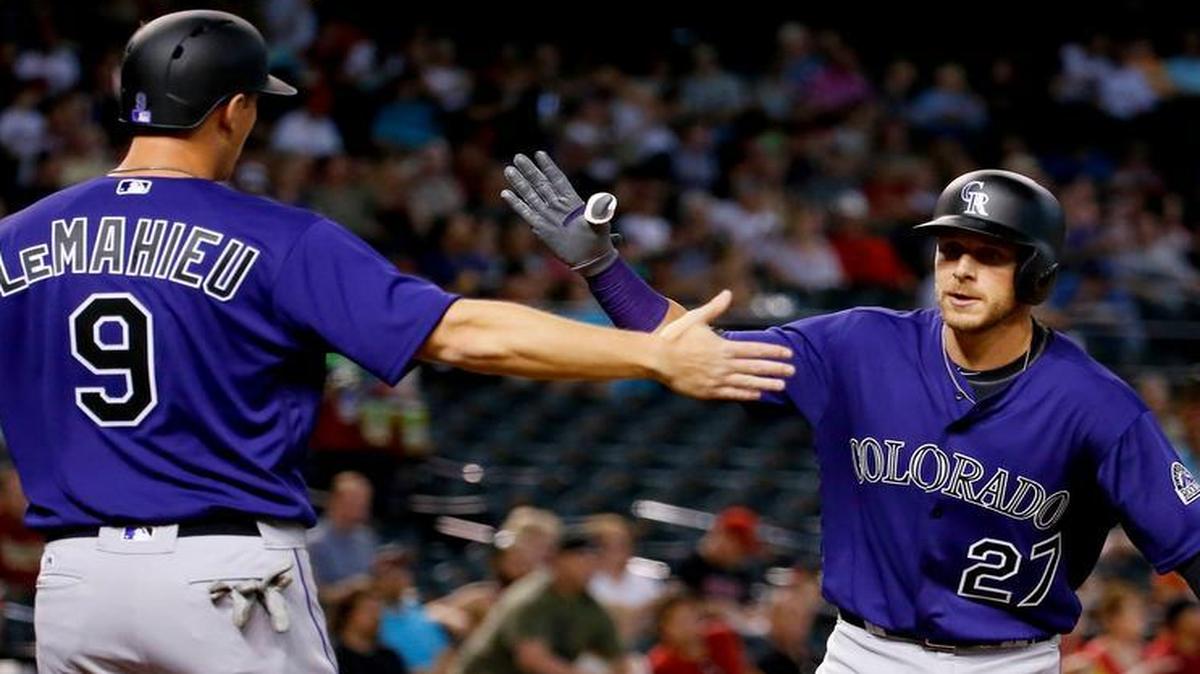Colorado Rockies shortstop Trevor Story, right, celebrates with teammate DJ LeMahieu (9) after hitting a two-run home run against the Arizona Diamondbacks during the first inningWednesday.