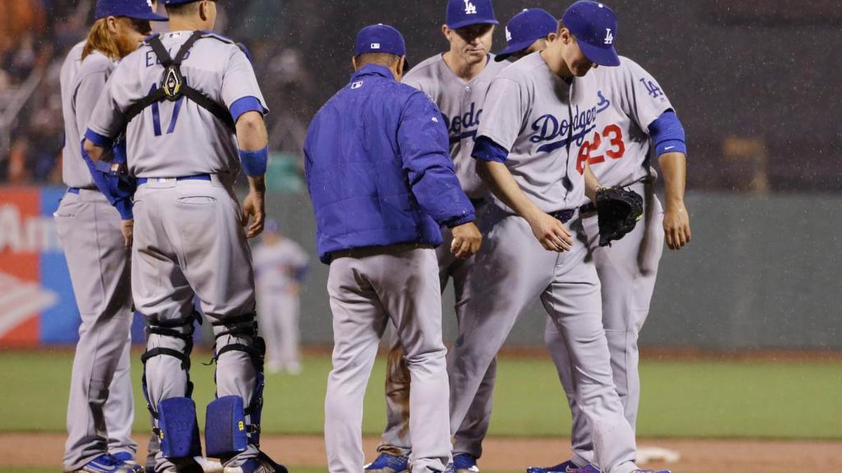Los Angeles Dodgers starting pitcher Ross Stripling, right, is pulled from the game by manager Dave Roberts, center, during the eighth inning of a baseball game Friday, April 8, 2016, in San Francisco.