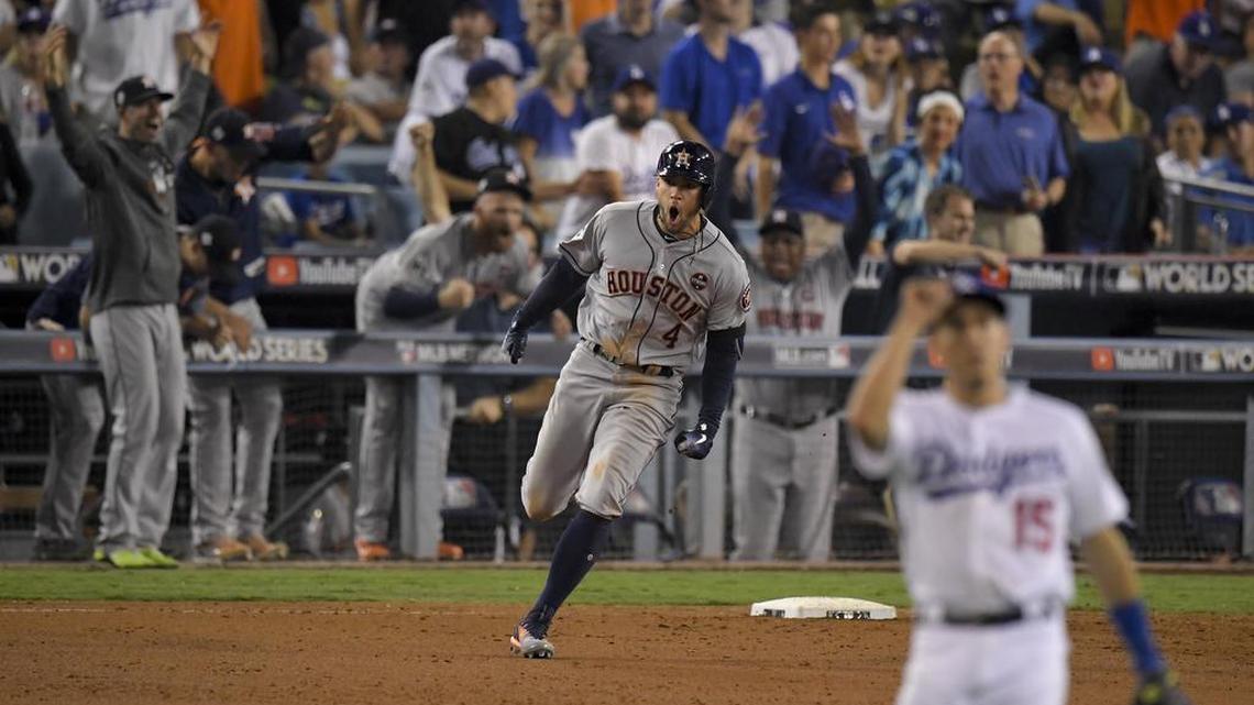 Houston Astros’ George Springer celebrates after a home run against the Los Angeles Dodgers during the 11th inning of Game 2 Wednesday night in Los Angeles.