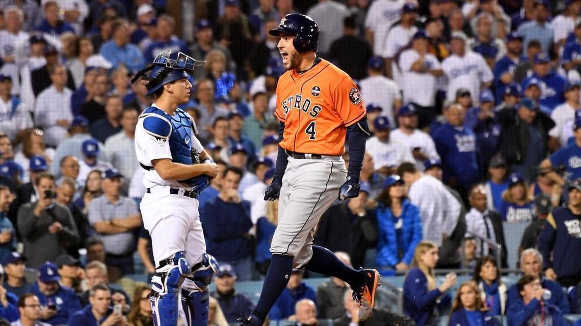 The Astros’ George Springer celebrates his two-run home run against Yu Darvish in front of Dodgers’ catcher Austin Barnes in the second inning of Game 7 of the World Series on Wednesday night at Dodgers Stadium. The Astros won 5-1 to earn their first ever championship.