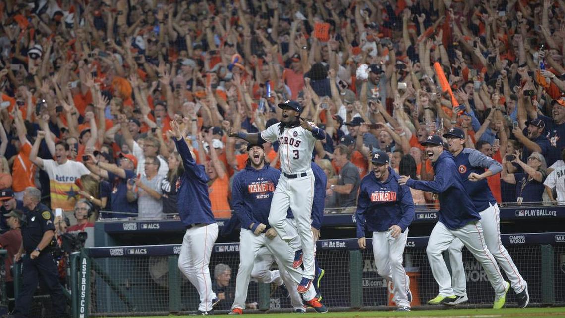 The Houston Astros storm the field to celebrate a series-clinching 4-0 win against the New York Yankees in Game 7 of the American League Championship Series in Houston.