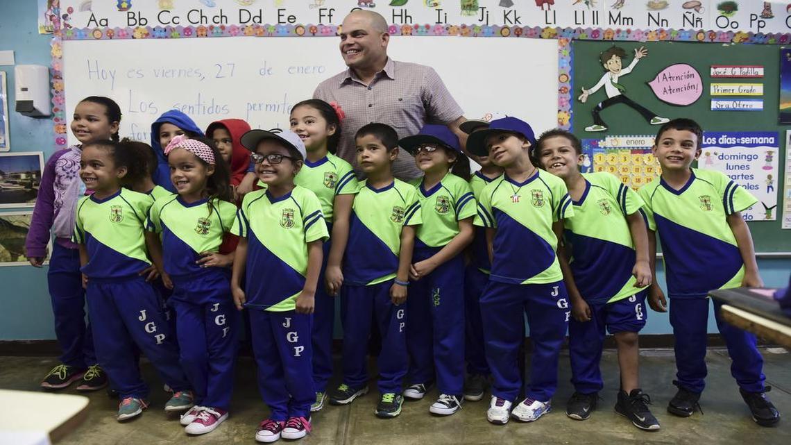 Students pose for a photo with Pudge Rodriguez, who was celebrated at his hometown school, José Gualberto Padilla Elementary, in Vega Baja, Puerto Rico, Friday, Jan. 27. Rodriguez is the fourth native Puerto Rican inducted into the Baseball Hall of Fame and is the youngest inductee at 45.