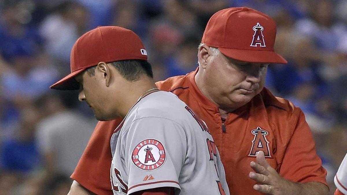 Cesar Ramos is pulled by manager Mike Scioscia in the eighth inning in a game last August while pitching for the Los Angeles Angels.