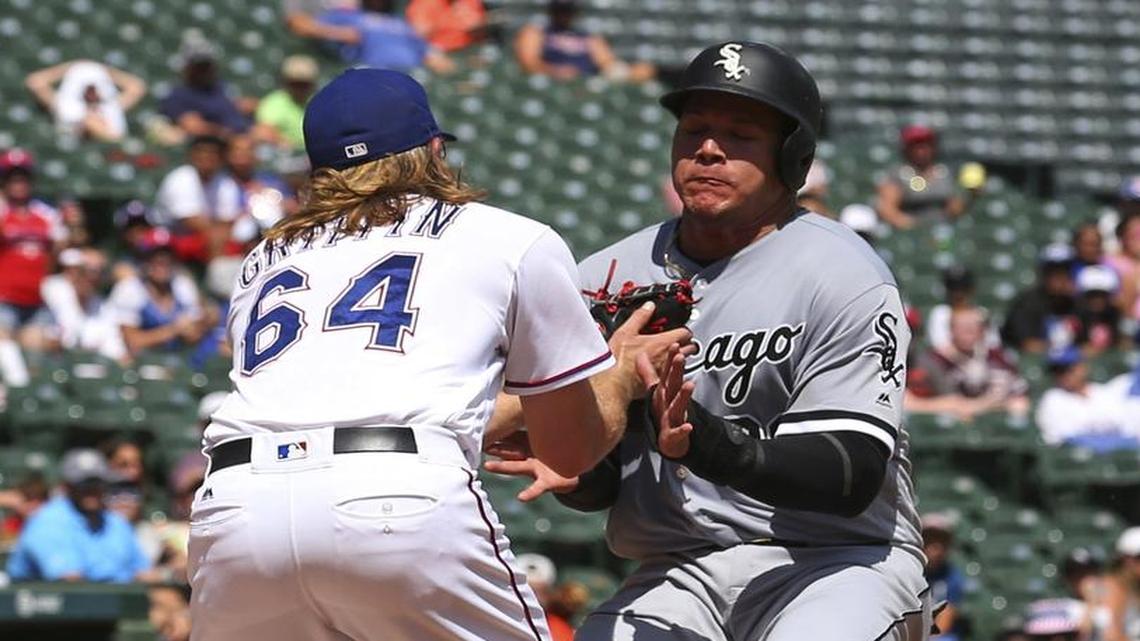 Rangers starter A.J. Griffin, left, who was tagged with the loss Sunday after giving up three runs on six hits and three walks, tags out White Sox base runner Avisail Garcia in the fourth inning.
