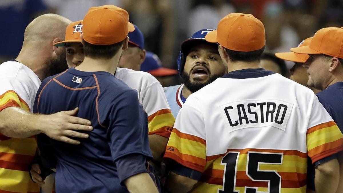
Rangers’ designated hitter Prince Fielder, center, confronts the Houston Astros’ Jed Lowrie, in navy blue, after both benches cleared in the ninth inning of a game in Houston on July 18.
