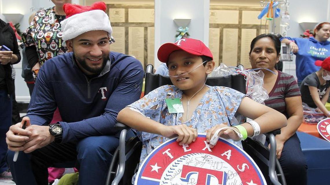 Rangers outfielder Nomar Mazara chats with 11-year-old Oscar Landaverde of Bridgeport during a team holiday visit to Cook Children’s Medical Center in Fort Worth on Wednesday.