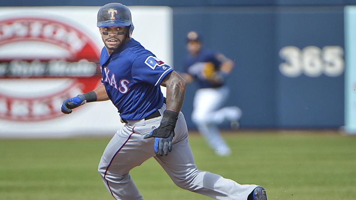 Rangers center fielder Delino DeShields makes it to second base on a bad pickoff throw during the third inning. The Brewers beat the Rangers 7-1 Saturday at Maryvale Baseball Ballpark in Phoenix.