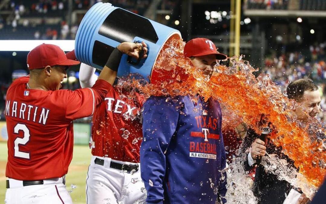 
Rangers starting pitcher Chi Chi Gonzalez gets doused by Leonys Martin (2) and Elvis Andrus following his MLB debut win over the Boston Red Sox Saturday night at Globe Life Park.
