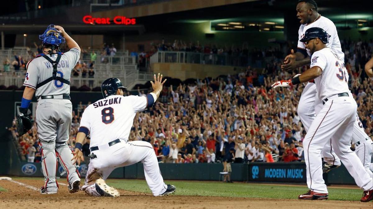 
Minnesota Twins rush to Kurt Suzuki as he scores the winning run on a double by Eduardo Escobar in the ninth inning.
