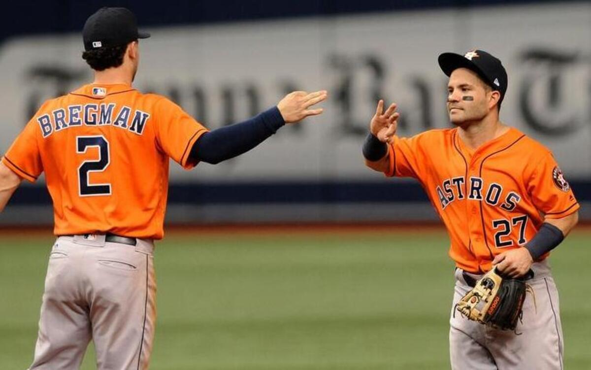 The Houston Astros’ Alex Bregman (2) and Jose Altuve (27) celebrate a 5-1 win over the Texas Rangers during a baseball game Thursday, Aug. 31, 2017, in St. Petersburg, Fla.