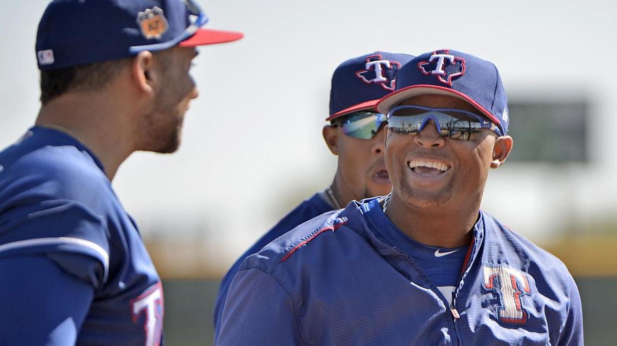 Rangers third baseman Adrian Beltre laughs with first baseman James Loney, left, during Thursday morning’s spring training workout in Surprise, Ariz.