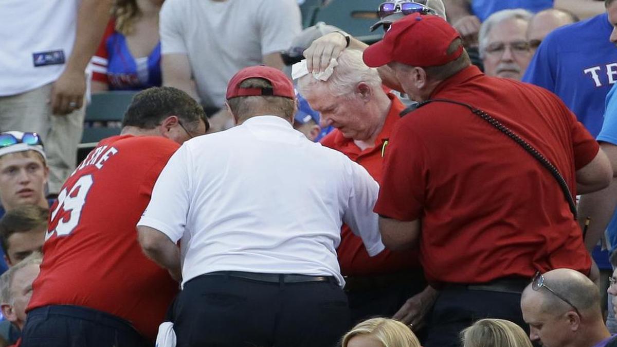 
An unidentified man is tended to after he was hit on the head by a foul ball during the fourth inning of Oakland’s 8-2 win against the Rangers Wednesday night at Globe Life Park.
