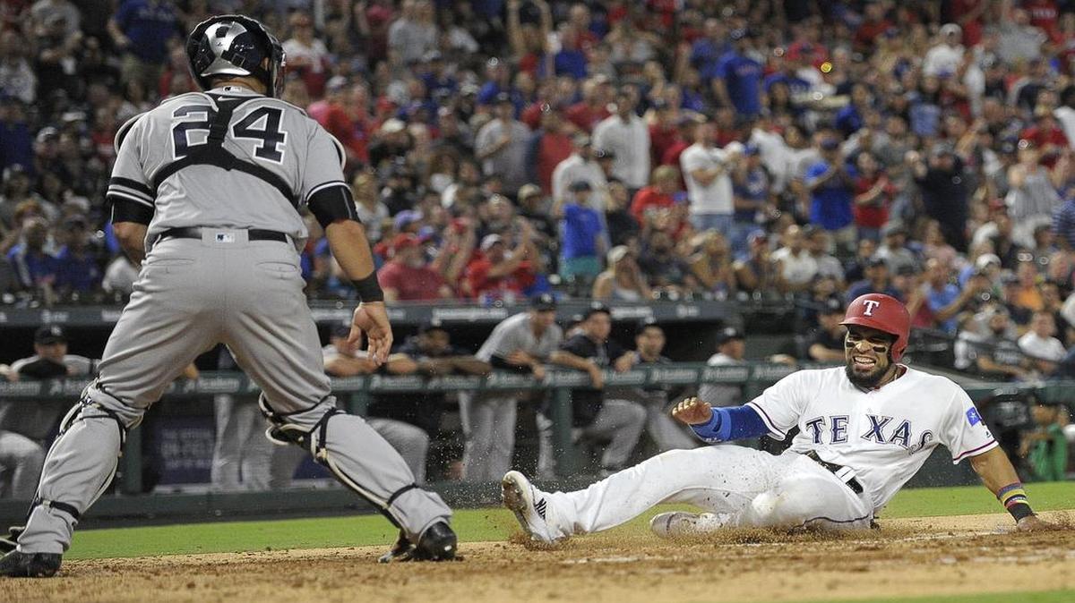 Texas Rangers catcher Robinson Chirinos (61) grimaces as he scores on a double by left fielder Delino DeShields during the third inning Friday. as the Texas Rangers play the New York Yankees at Globe Life Park in Arlington, TX, Friday, Sept. 8, 2017. Chirinos, who has reached base safely in 23 consecutive games, sat out Saturday, Sept. 9.