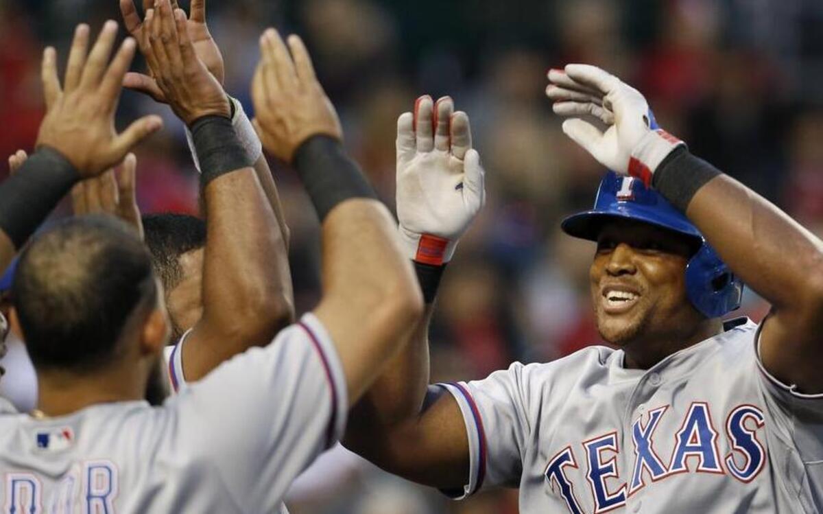 Rougned Odor greets Adrian Beltre at the top of the Rangers’ dugout after the third baseman started the fourth inning with a home run.