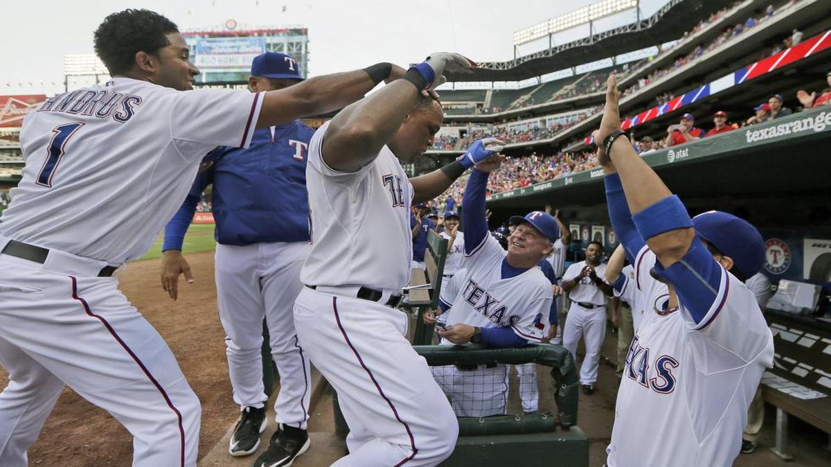 
Rangers slugger Adrian Beltre, center left, celebrates his 400th home run with Elvis Andrus (1), Robinson Chirinos, right, and bench coach Steve Buechele during the first inning Friday against the Indians.
