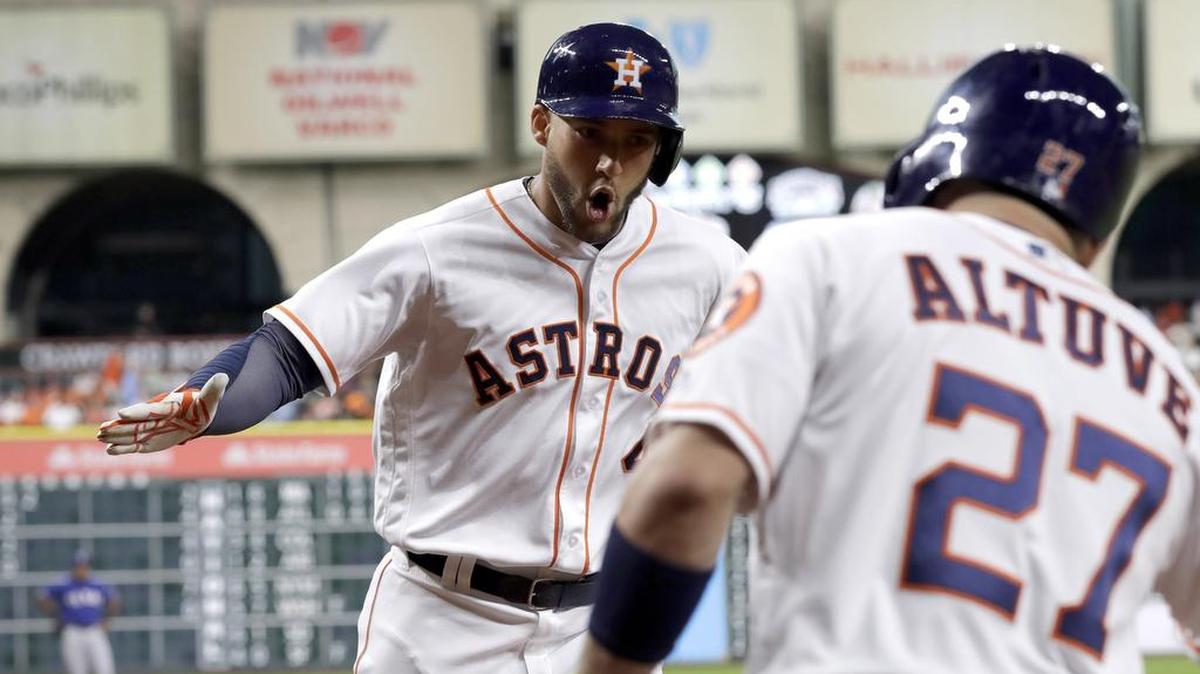Astros right fielder George Springer, left, celebrates Wednesday with Jose Altuve after hitting a leadoff home run against Rangers left-hander Derek Holland.