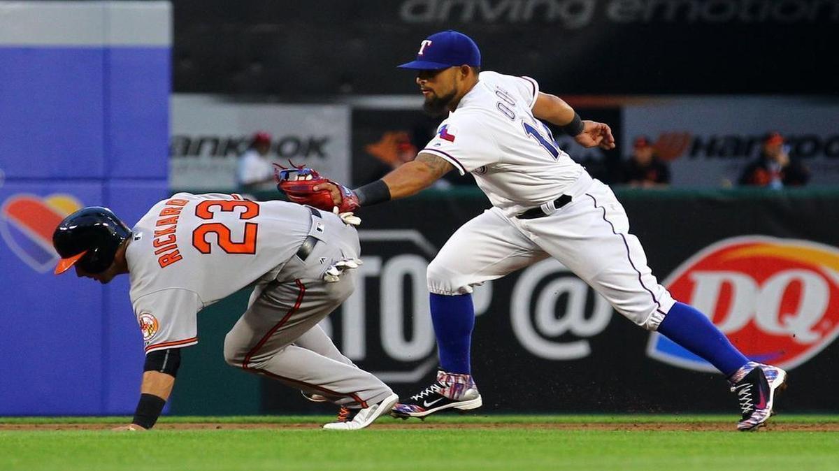 The Orioles’ Joey Rickard is tagged out by Rangers second baseman Rougned Odor in the third inning at Globe Life Park Thursday. Texas beat Baltimore 6-3.