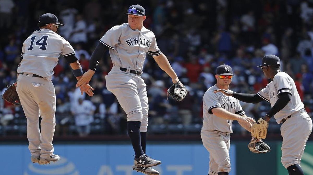 New York Yankees second baseman Starlin Castro (14) and New York Yankees right fielder Aaron Judge (99) leap in the air to celebrate after the New York Yankees beat the Texas Rangers 3-1 in Arlington, Saturday, September 9, 2017.