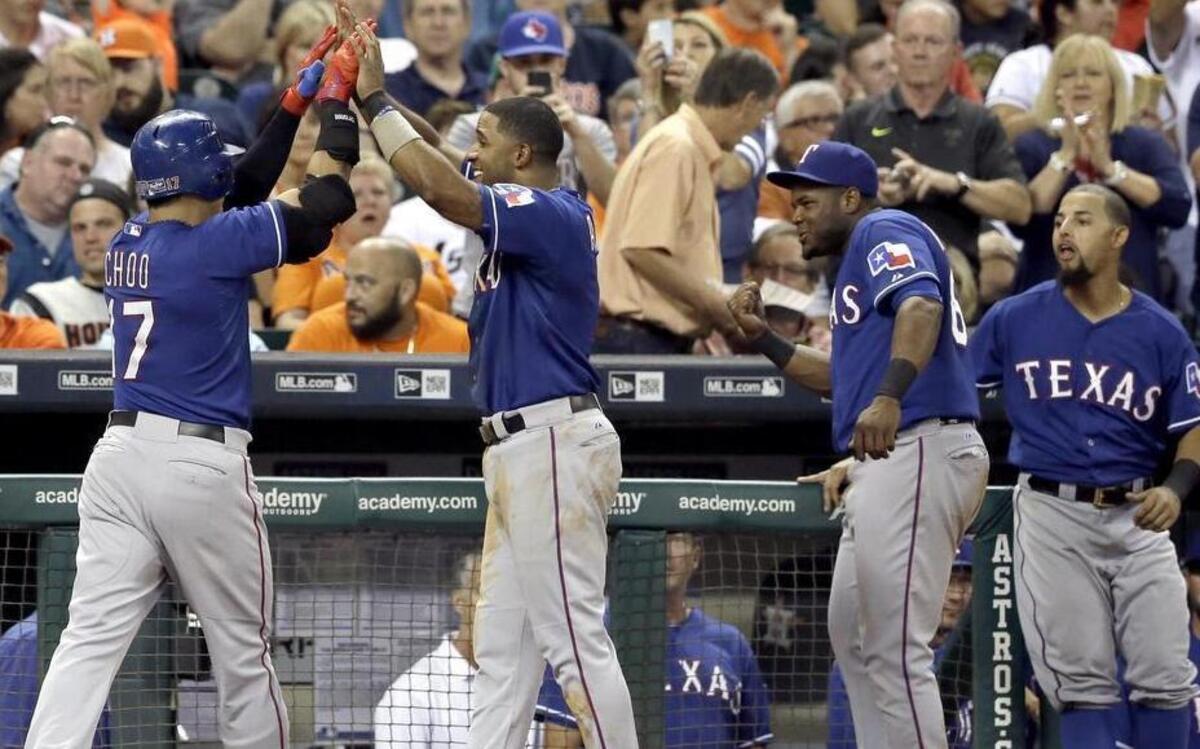 
Shin-Soo Choo, left, celebrates after belting a two-run home run in the Rangers’ three-run fourth inning.

