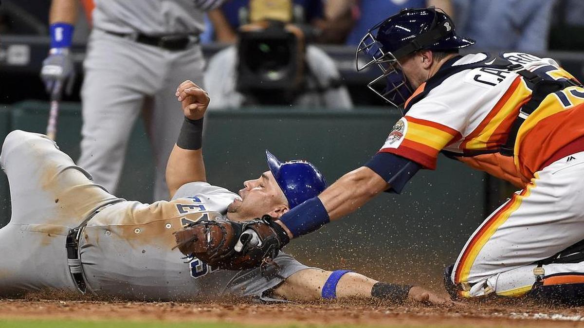 Texas Rangers' Carlos Beltran, left, is tagged out at home by Houston Astros' catcher Jason Castro in the seventh inning of a baseball game, Saturday in Houston. Beltran was out of the lineup Monday against Colorado as he continued to nurse a bruised leg.