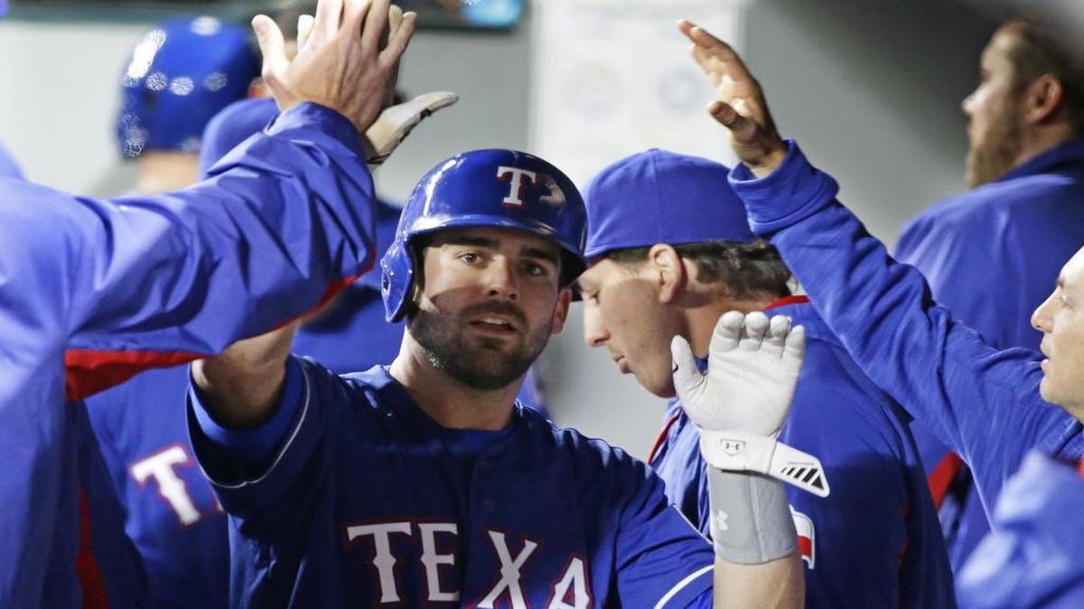 Rangers catcher Brett Nicholas, greeted in the dugout after scoring in the seventh, gave his team a big hand with strong defense and two hits in his major league debut Monday in Seattle.
