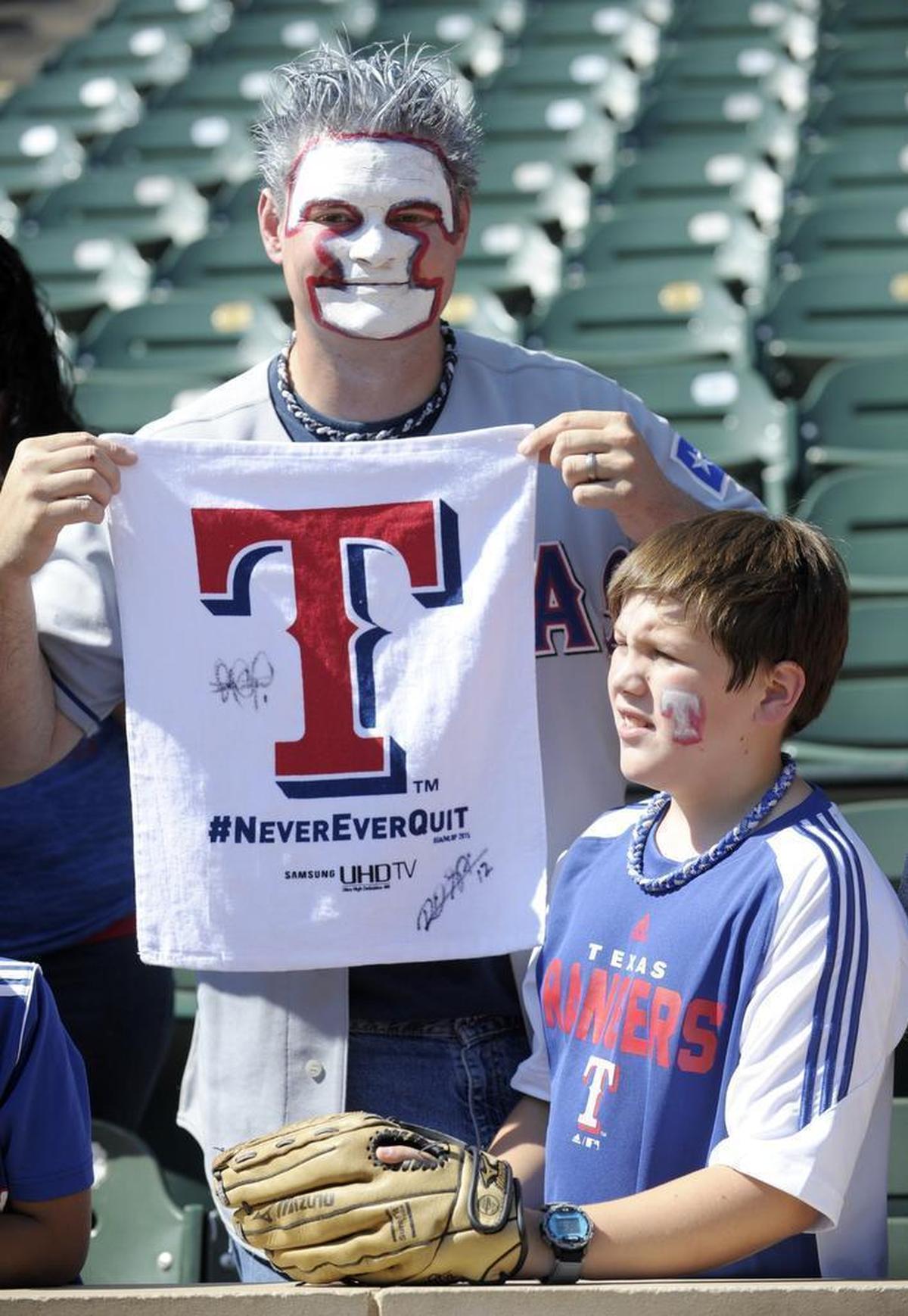 William De La Paza, 34, and son Micah De La Paza, 10, of Arlington, watched batting practice before Monday’s Game 4 between the Rangers and Blue Jays at Globe Life Park.