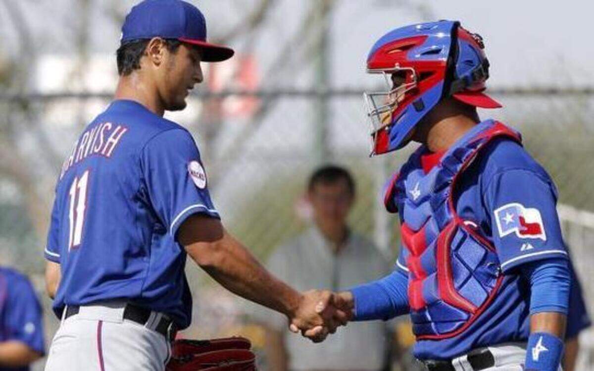 
Rangers pitcher Yu Darvish and catcher Carlos Corporan shake hands after the first spring training workout of 2015. It was the first time Corporan had caught Darvish.
