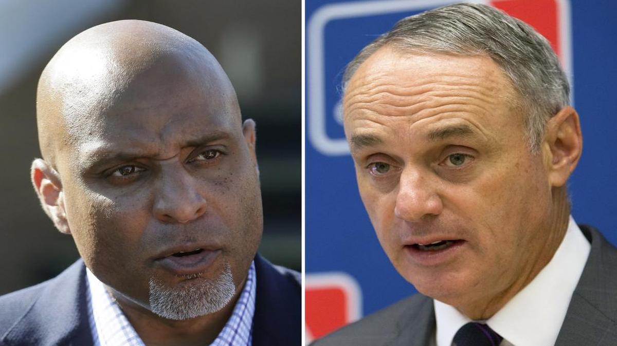 Tony Clark, left, the executive director of the MLB players association, helped negotiate a new five-year labor contract with Commissioner Rob Manfred and owners hours before the old deal was set to expire.