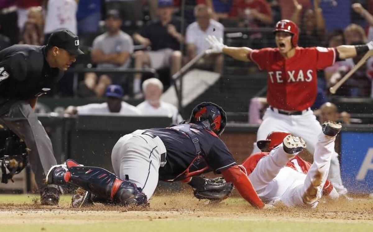 
Elvis Andrus of the Rangers beats the tag by Indians catcher Roberto Perez. Andrus had stolen second base and scored on Perez’s throwing error.

