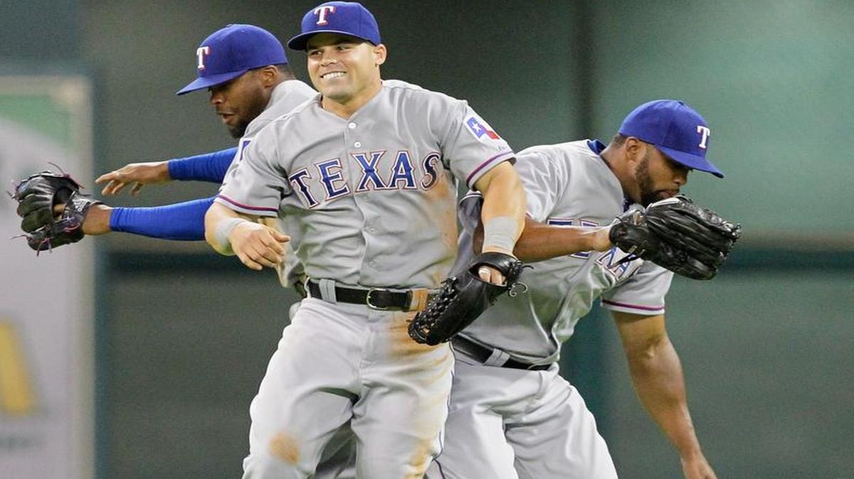 
Jake Smolinski, center, celebrates with Delino DeShields Jr., left, and Carlos Peguero after the Rangers’ 2-1 victory Monday night over the Astros. 


