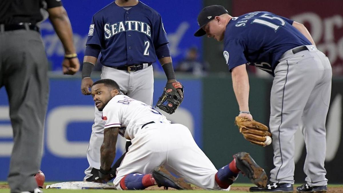 Texas Rangers center fielder Delino DeShields (3) was tagged out at second base by Seattle Mariners third baseman Kyle Seager (15) during the third inning Wednesday in Arlington.