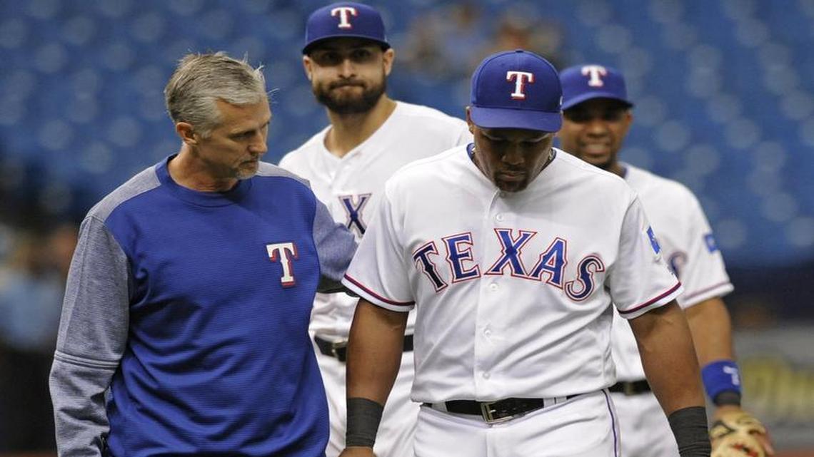 Adrian Beltre, right, walks to the dugout with Rangers’ head trainer Kevin Harmon straining his left hamstring during the seventh inning Thursday afternoon at Tropicana Field in St. Petersburg, Fla. Joey Gallo, center, and Elvis Andrus watch them walk to the dugout.