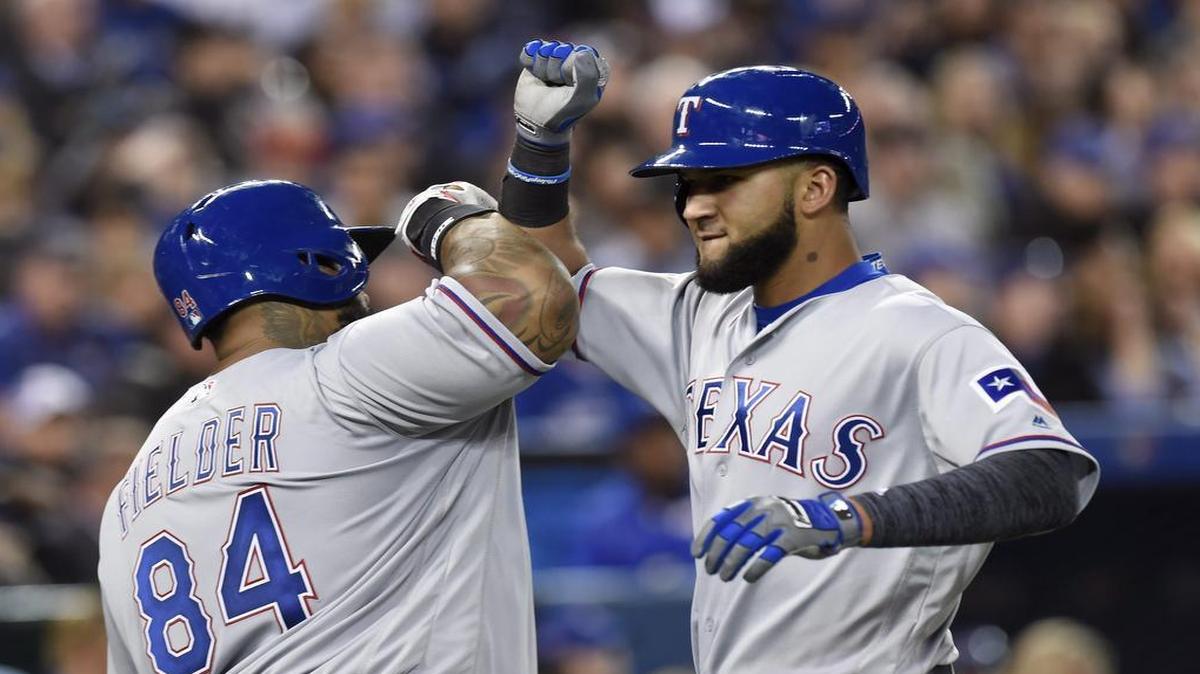 Rangers outfielder Nomar Mazara, right, celebrates with Prince Fielder after hitting a go-ahead solo home run against the Blue Jays.
