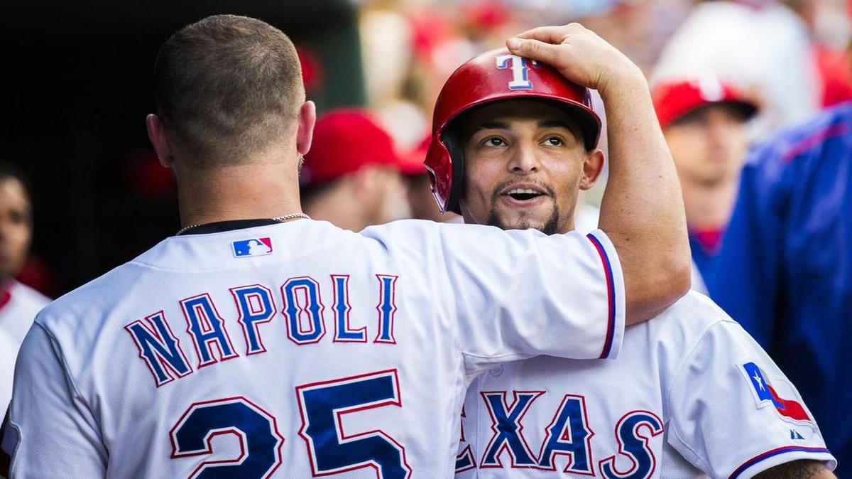 
Rangers second baseman Rougned Odor, right, gets a hug from Mike Napoli in the dugout after Odor’s second-inning home run Tuesday at Globe Life Park. Seattle beat Texas 3-2 to even the series.
