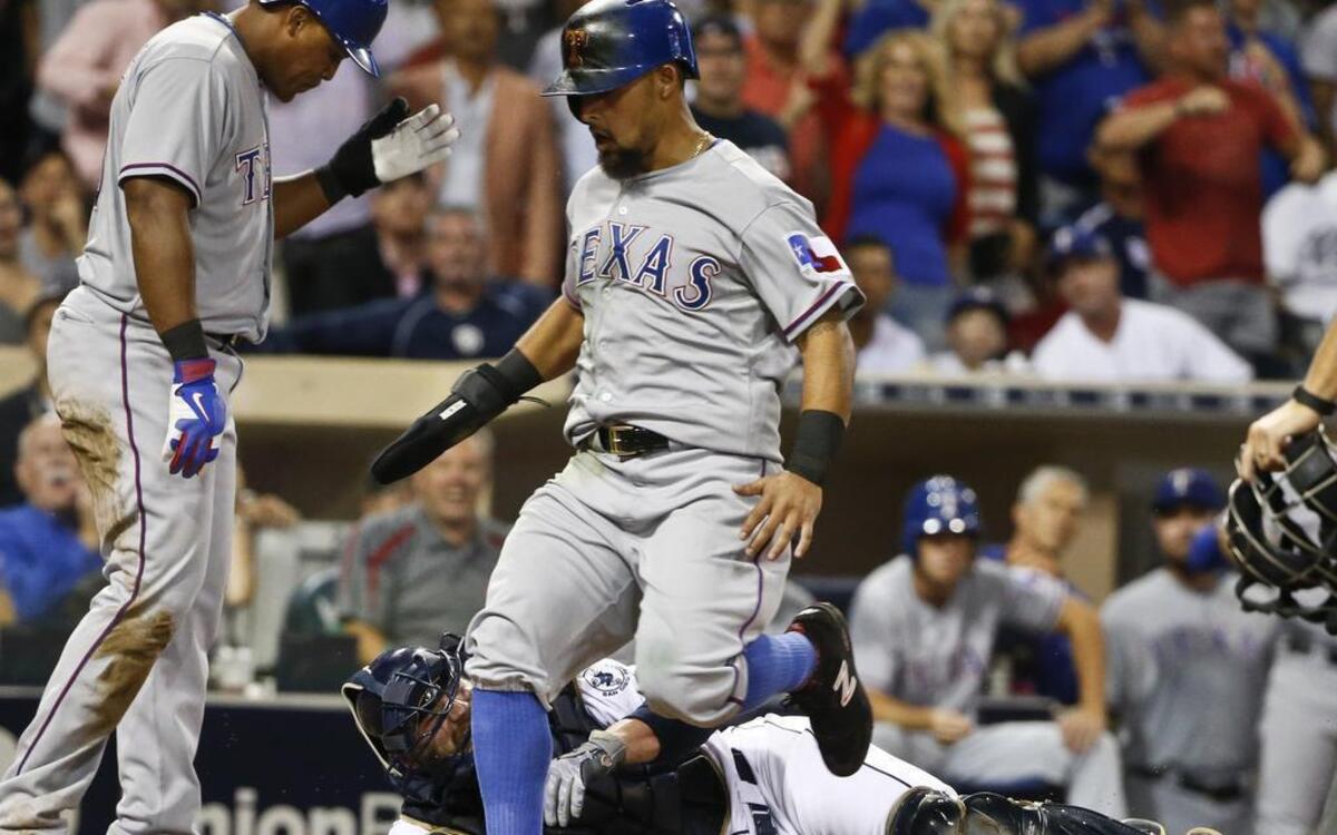 
Rougned Odor scores after Adrian Beltre scored and knocked the ball out of of the glove of Padres’ catcher Derek Norris in the seventh inning Tuesday at Petco Park in San Diego. Norris was injured on the play and left the game. Texas beat San Diego, 8-4, to even the series.
