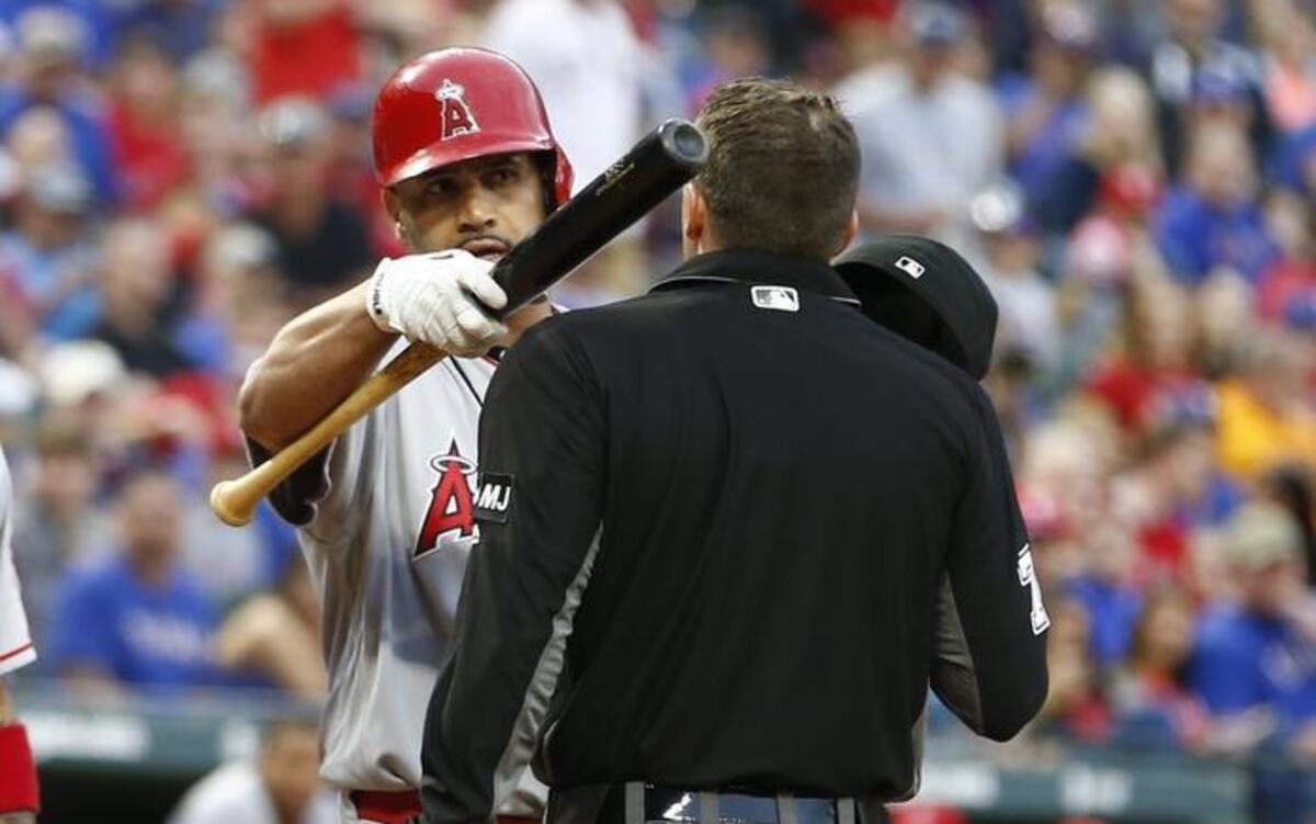 Albert Pujols argues with umpire Adam Hamari after an inside pitch by Yu Darvish during the fifth inning Saturday. Pujols was pointing at the Rangers’ dugout, specifically Chi Chi Gonzalez.